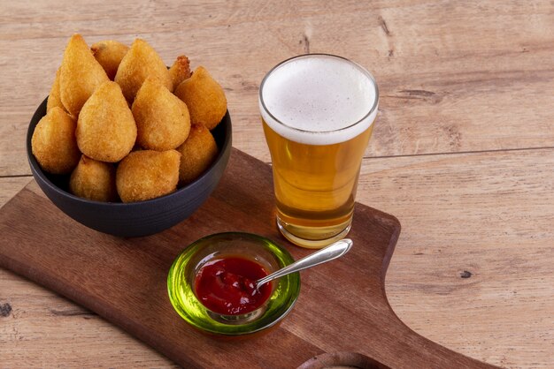 Traditional Brazilian fried chiken snack and a glass of beer