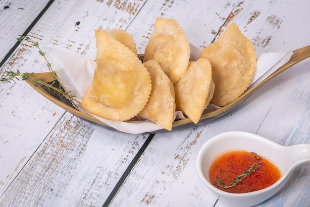 Traditional Brazilian pastry where it is called pastel On white table with top view