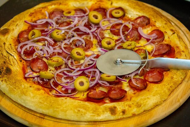 Traditional Brazilian pepperoni pizza in selective focus Calabresa pizza