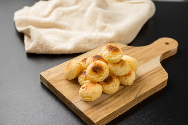 Traditional Brazilian Snack Cheese Bread on a chopping board
