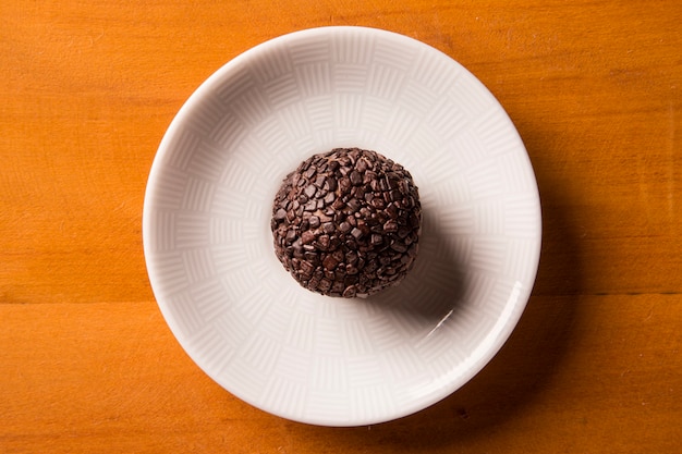 Traditional brazilian sweet- brigadeiros - over wood surface