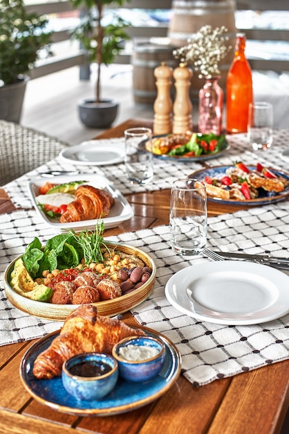 Traditional breakfast with croissants and coffee served on wooden table, time for breakfast or lunch