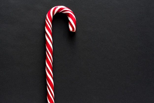 Traditional  candy cane on black background. New Year and Christmas 