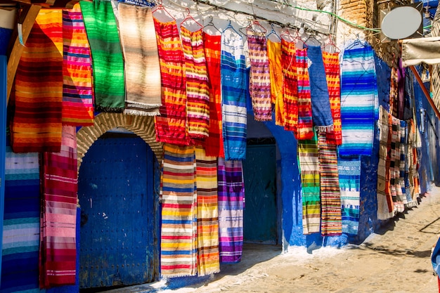 Traditional carpets on the blue Chefchaouen street. 