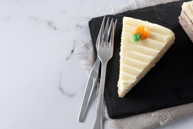 Traditional carrot cake portion on white marble