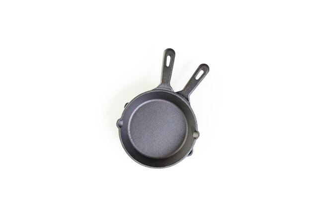 Traditional cast iron skillet on a white background.