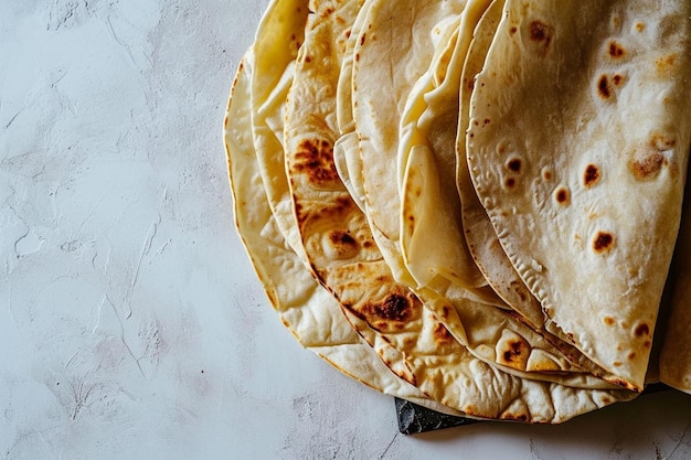 Traditional chapati cakes on a blackboard are isolated on a white background in closeup