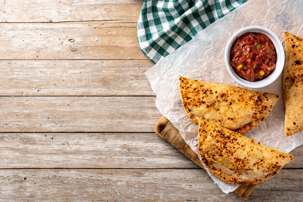 Traditional Chilean empanadas on rustic wooden table