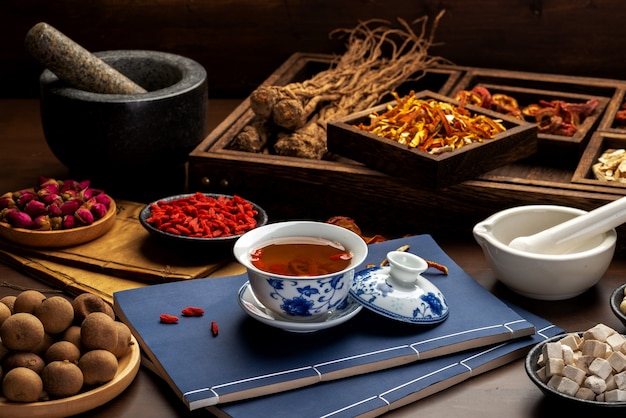 Traditional Chinese health tea and classical medical books on the table