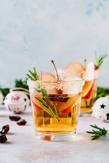 Traditional Christmas apple punch with cinnamon, anise and sprigs of rosemary