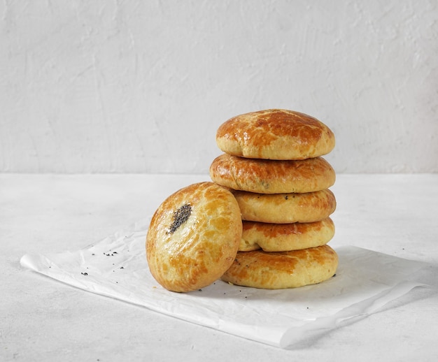 Traditional Christmas Austrian pies Mohnzelten with poppy seeds filling on light table copy space