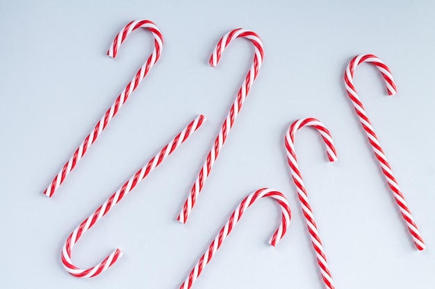 Traditional Christmas candy canes on gray background top view