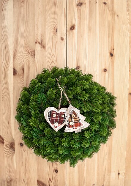 Traditional christmas decoration evergreen wreath on wooden background