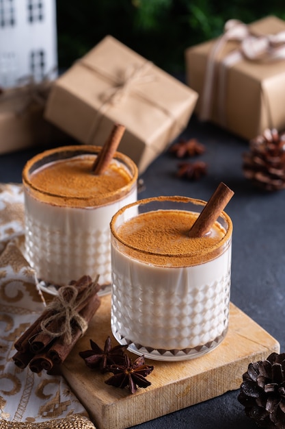 Traditional christmas drink and dessert eggnog with handmade gift boxes