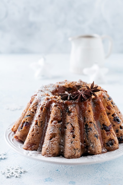 Traditional Christmas fruit cake, pudding on white plate