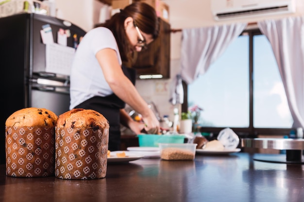 Traditional Christmas Panettone with dried fruits. Cook preparing Christmas bread.