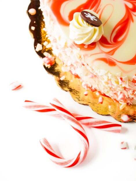 Traditional Christmas White Chocolate Peppermint Cheesecake on white background.