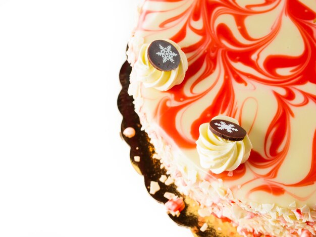 白い背景の上の伝統的なクリスマスホワイトチョコレートペパーミントチーズケーキ。