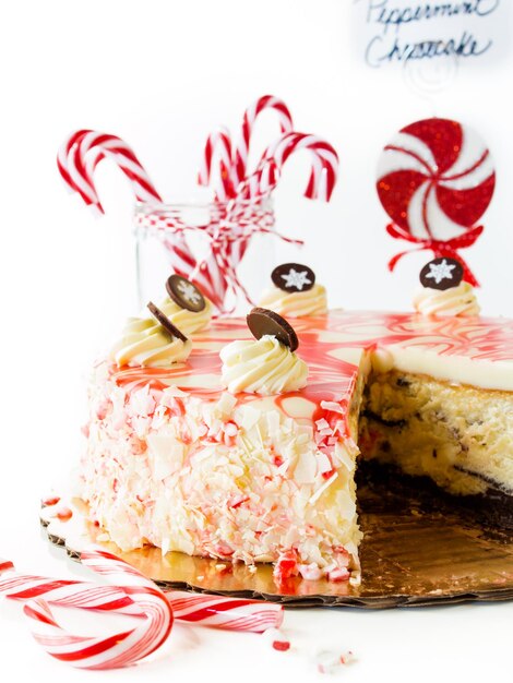 Traditional Christmas White Chocolate Peppermint Cheesecake on white background.