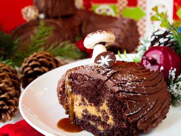 Traditional Christmas Yule Log cake decorated with marzipan mushrooms.