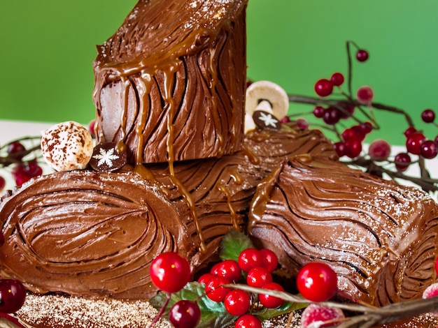 Traditional Christmas Yule Log cake decorated with marzipan mushrooms.