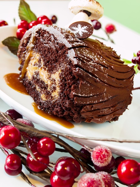 Traditional Christmas Yule Log cake decorated with marzipan mushrooms.