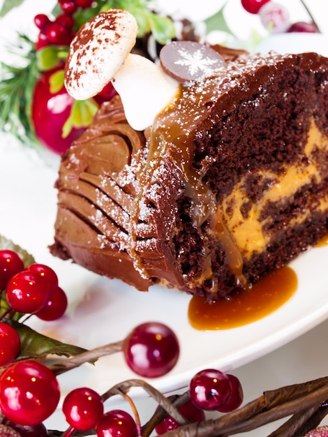 Traditional Christmas Yule Log cake decorated with marzipan mushrooms.