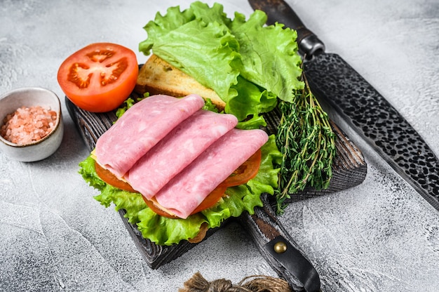 Traditional club sandwiches with turkey ham, cheese, tomatoes and lettuce