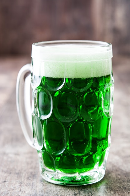 Traditional cold green beer for Saint Patrick's Day on wooden table