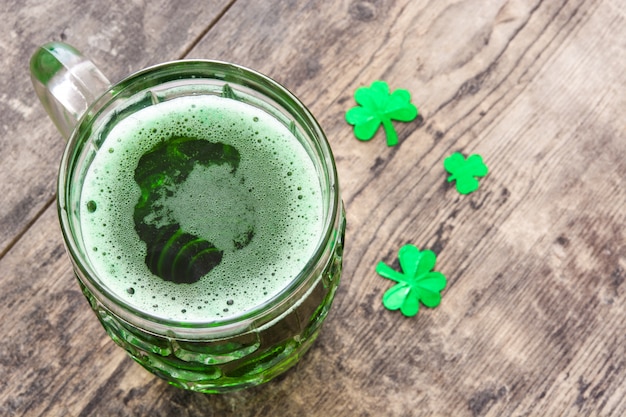 Traditional cold green beer for Saint Patrick's Day on wooden table