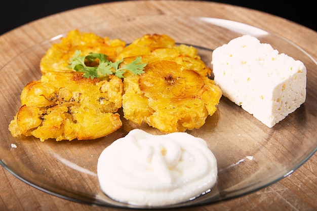 Traditional colombian breakfast with fried plantain and cheese