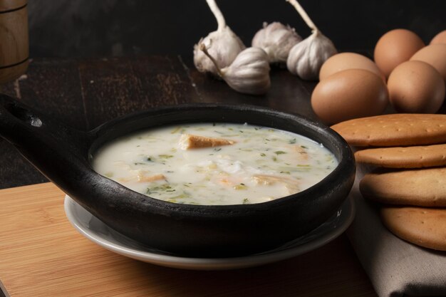 Traditional Colombian soup changua with round pieces of crunch biscuits