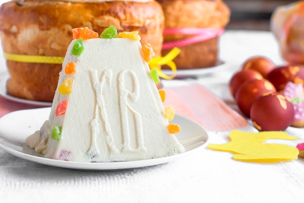 Traditional curd Easter cake with candied fruits on light table 