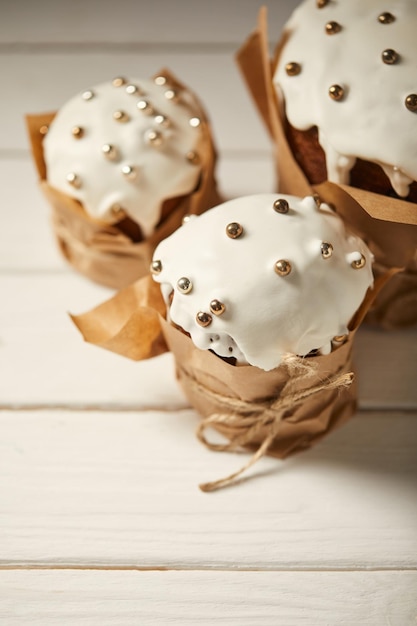 Traditional delicious easter cakes on white wooden surface