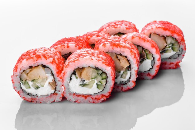 Traditional delicious fresh sushi roll set on a white background with reflection