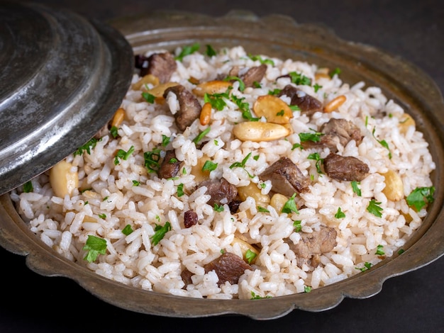 Traditional delicious Turkish food rice pilaf with pine nuts and currants Turkish name bademli ic pilav or pilaf