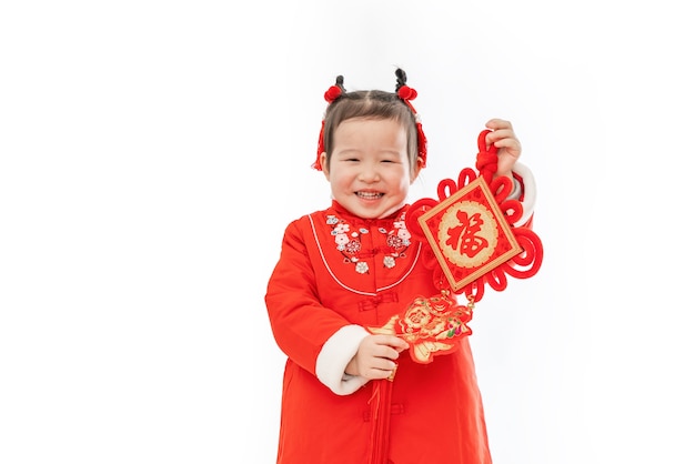 Traditional dress of Chinese baby girl with traditional Pendant in her hand