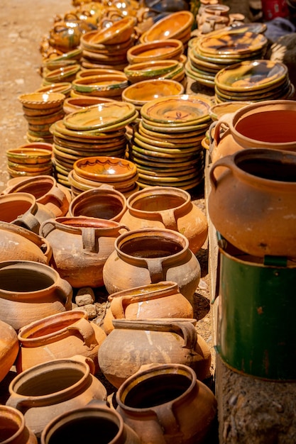 traditional earthenware pots on display at a local market