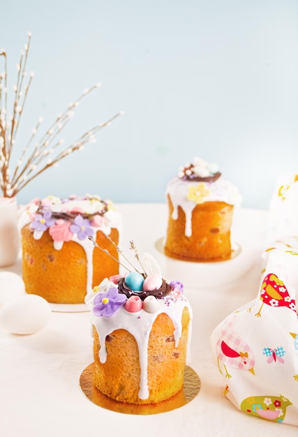 Traditional Easter cake sweet bread kulich decoratedwith candies. sugar flower, meringue icing