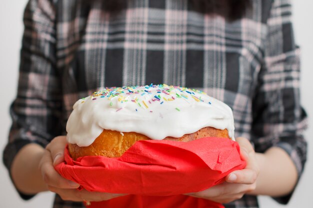 Traditional Easter cake in womans hands.