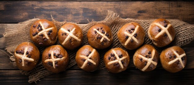 Traditional Easter Hot Cross Buns photographed from above on a wooden background with copy