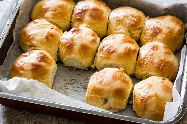 Traditional Easter hot cross buns on wooden table