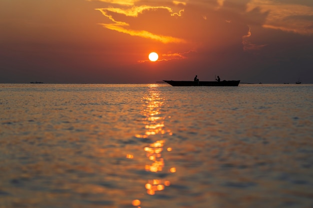 Traditional fisherman dhow boat during sunset on Indian ocean in island Zanzibar, Tanzania, East Africa