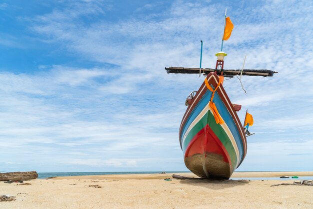 Traditional fishing boat on the beach and blue sky