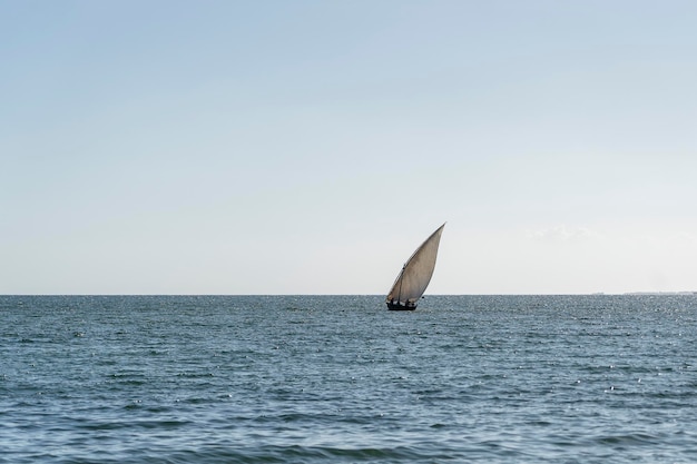 Traditional fishing sailing boat during sunset on Indian ocean in island Zanzibar Tanzania Africa