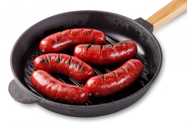 Traditional fragrant meat fried sausages in a cast-iron frying