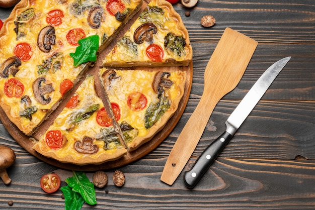 Traditional french Baked homemade quiche pie on wooden board