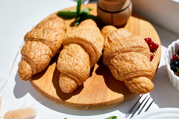 Traditional French croissant on white table