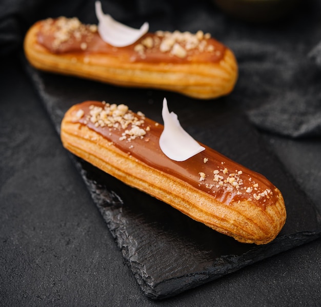 Traditional french dessert eclair with caramel