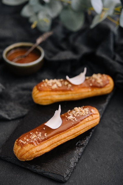 Traditional french dessert eclair with caramel